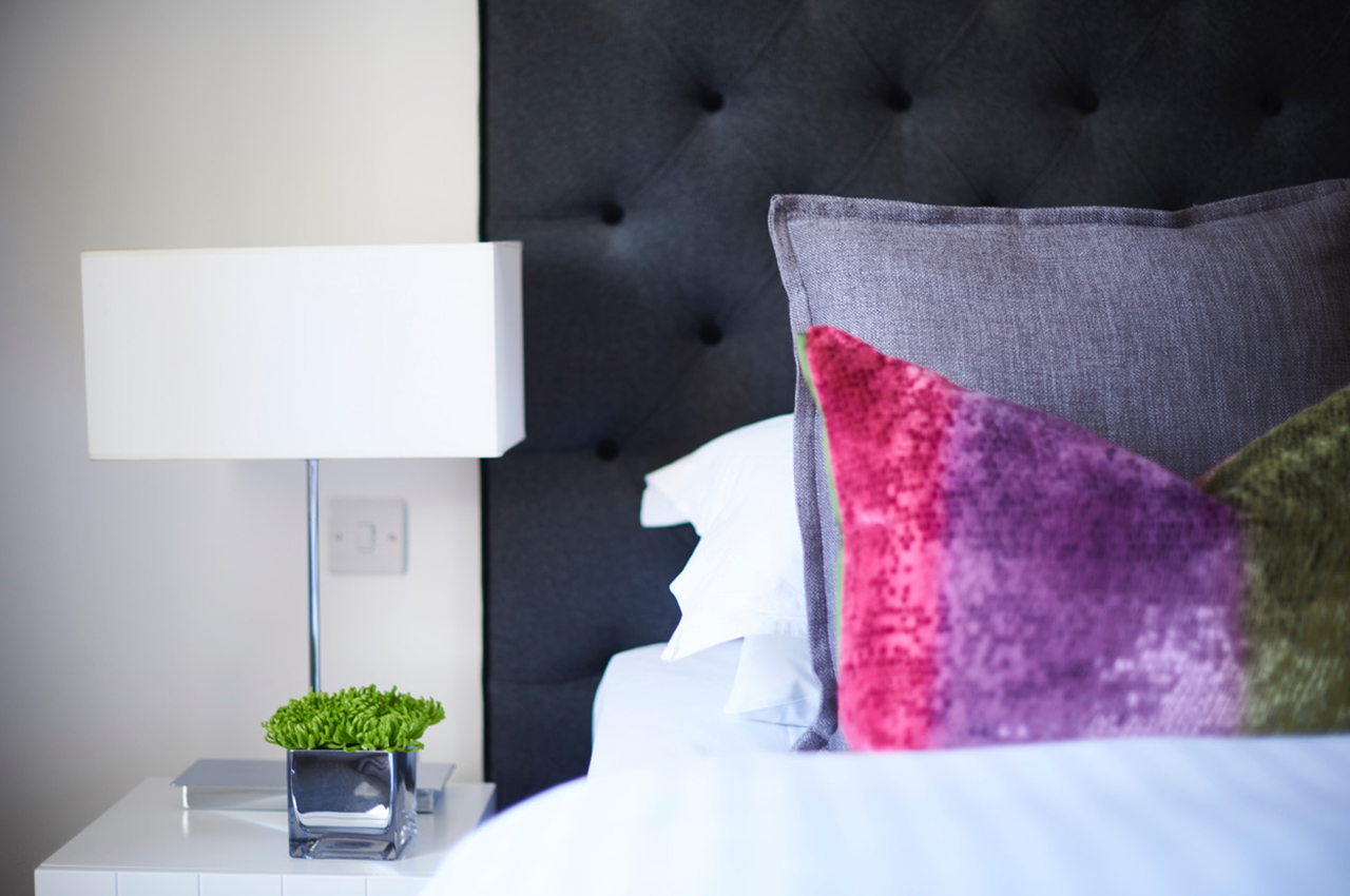 Caol Ila bedroom at 94DR — tufted headboard detail