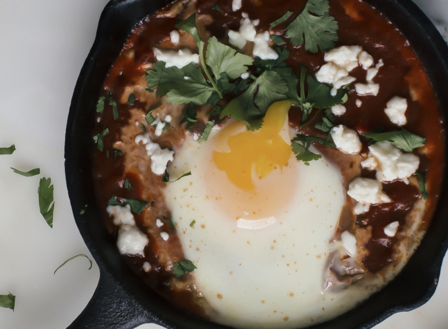 Baked breakfast eggs served in a cast-iron pan