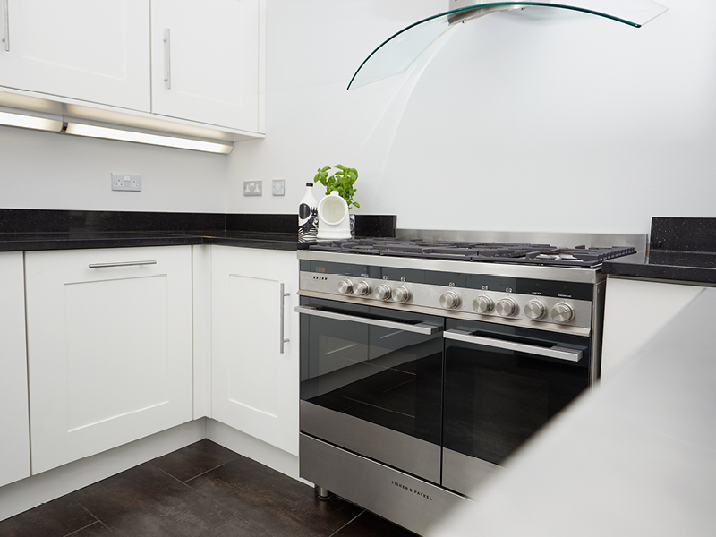 The chef’s kitchen with professional gas stove and double ovens